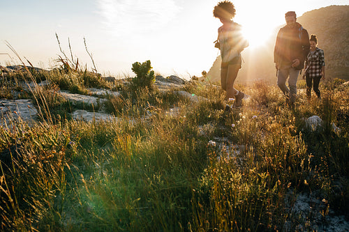 Young men and women hiking in countryside