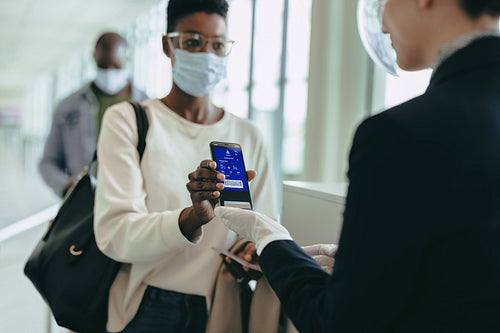 Female in pandemic with air ticket at airport