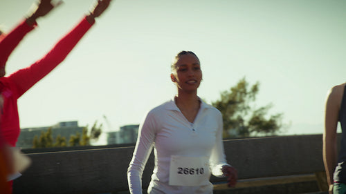 Runners high-five before a running event