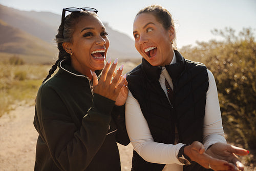 Two women laughing outdoors together