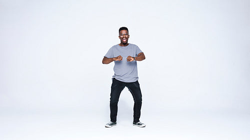 Happy african man dancing in joy