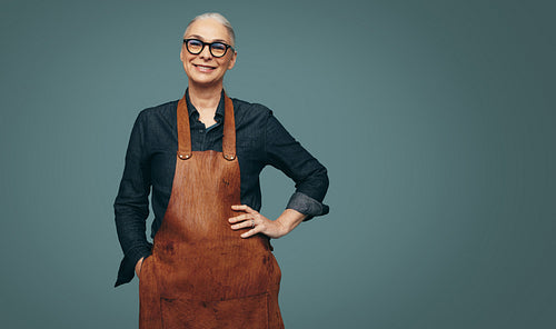 Happy jewellery maker smiling in a studio