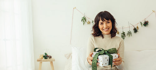 Woman at home with a christmas gift