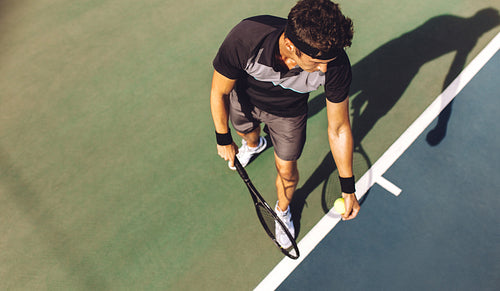 Tennis player with racket ready to serve