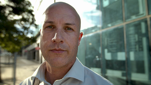 Mature businessman staring at camera outdoors