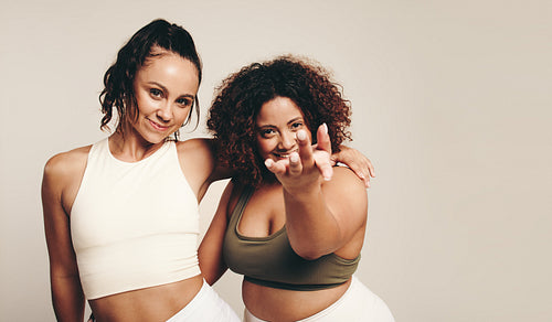 Vibrant studio vibes: Young women celebrating fitness through dance and exercise