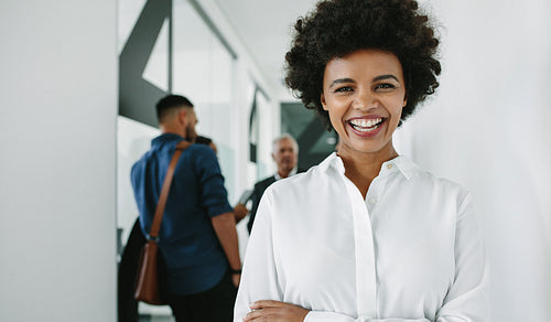 Cheerful business woman in office hallway