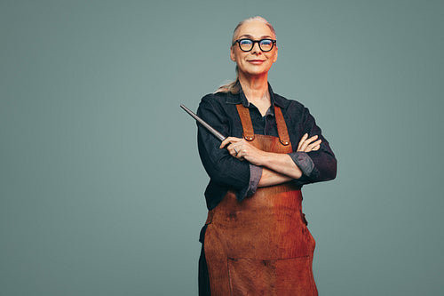 Jewellery maker holding a ring mandrel in a studio