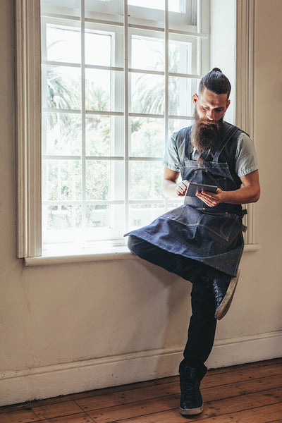 Hairdresser with digital tablet at his salon