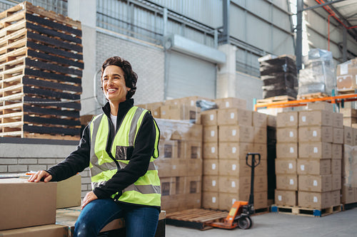 Female warehouse employee looking away with a happy smile
