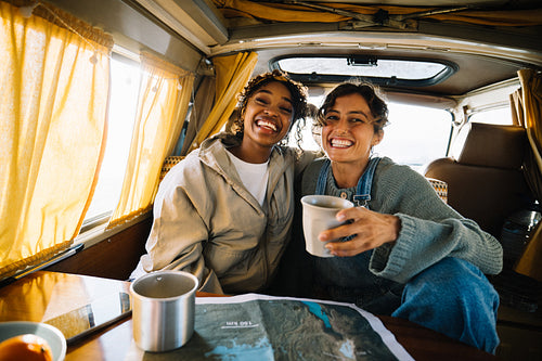 Friends on a road trip in a cozy van