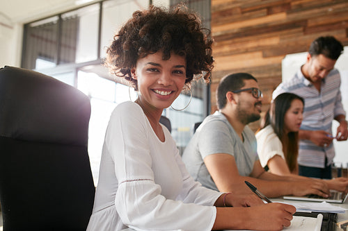 Attractive young woman sitting at conference room