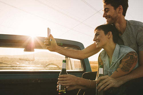 Couple enjoying on a road trip in their pick up truck
