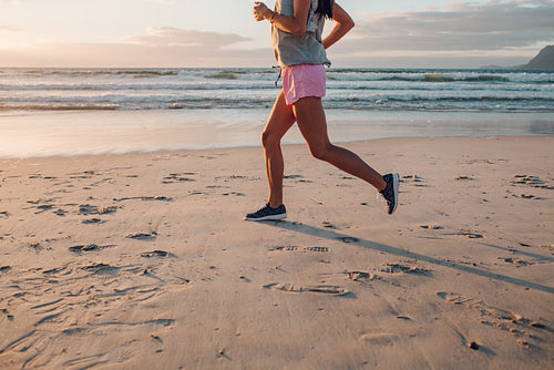 Young woman jogging on the beach