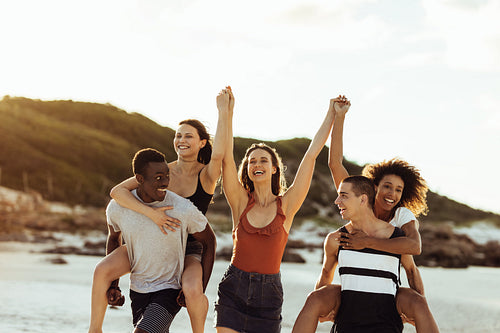 Group of young friends enjoying on beach