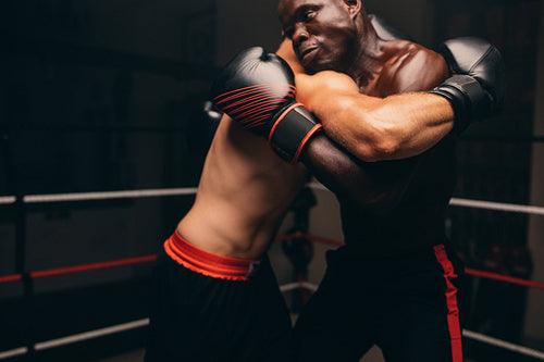 Male fighters fighting in a boxing ring