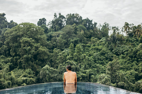 Young man relaxing in a swimming pool