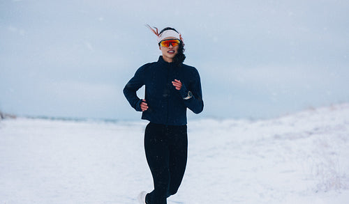 Snowy trail running guides the woman through winter fitness outdoors