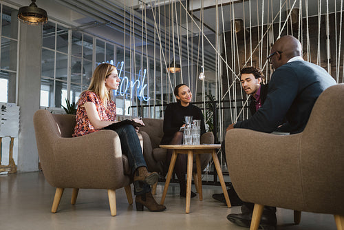 Diverse group of young people having a meeting in lobby