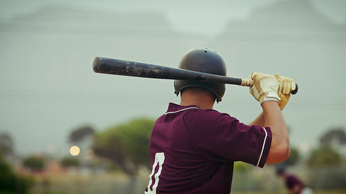 Baseball player hits and runs, successfully sliding into base