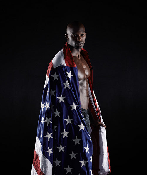 Afro american athlete wrapped in USA flag