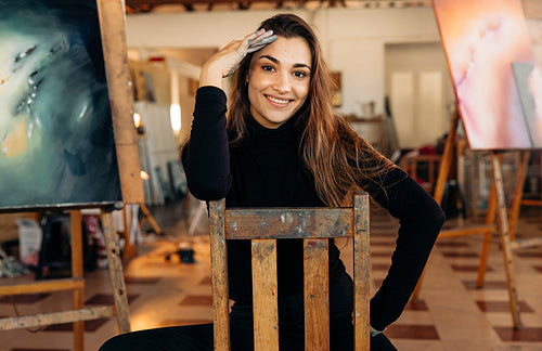 Successful female painter smiling at the camera