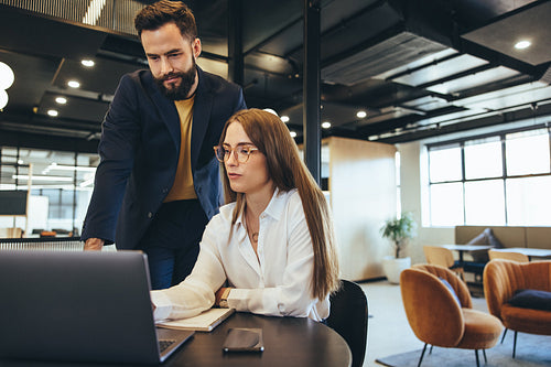 Two go-getters working together in an office space