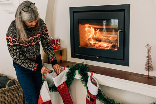 Senior woman decorating home for christmas