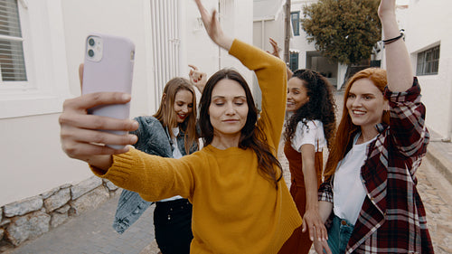 Women filming dancing with friends on the phone