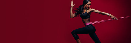 Strong woman exercising with a resistance band