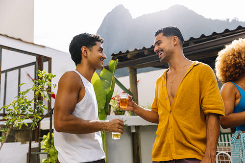 Two men enjoying beers at a rooftop in Rio de Janeiro