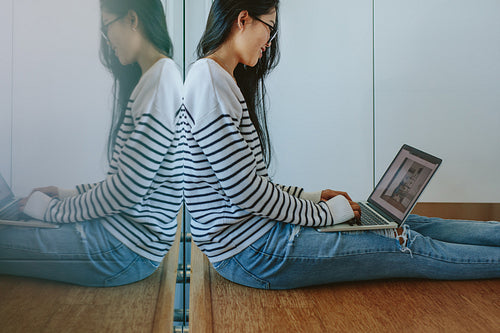 Woman working on laptop at home