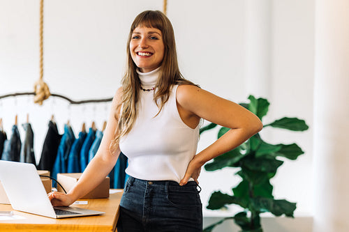 Happy business owner smiling cheerfully in her shop