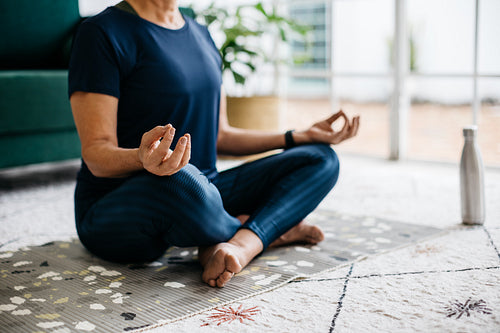 Senior woman doing a breathing exercise in a yoga meditation session