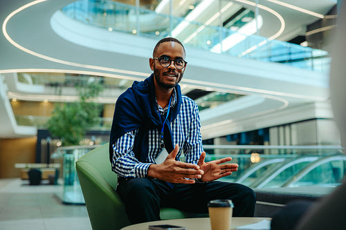 Professional African male accountant having a business discussion in a modern corporate environment
