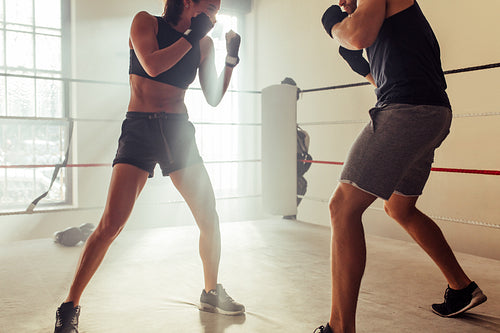 Two young fighters facing each other in a boxing ring