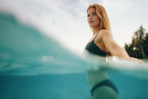 Young woman in a tropical ocean enjoying a sunny day