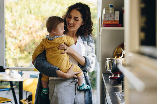 Mother with baby in kitchen