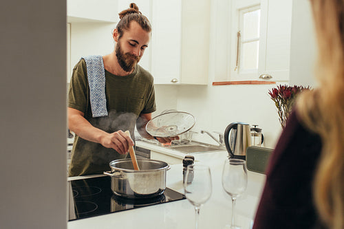 Man cooking food in kitchen at home