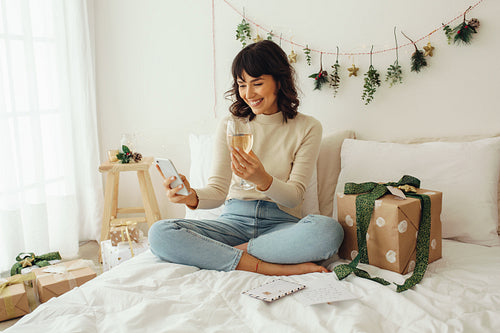 Woman celebrating christmas with friends over video call