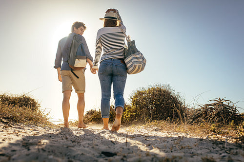Couple on a holiday walking on beach