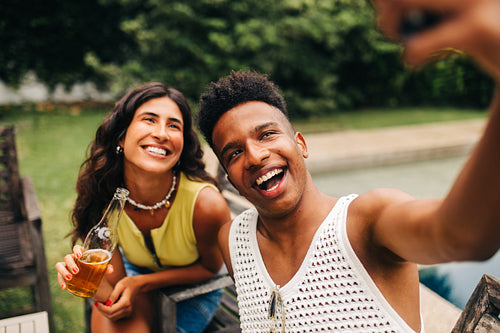Friends take a sunny selfie at a park