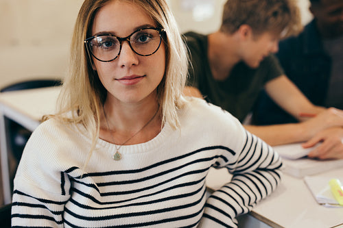 Confident female student in classroom
