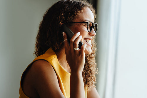 Talking on phone in a bright indoor workspace