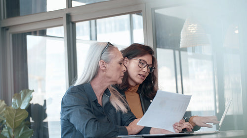 Two business woman working together in office