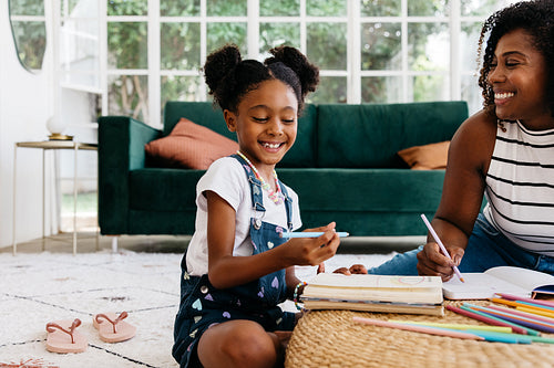 Mother and daughter bonding over drawing at home