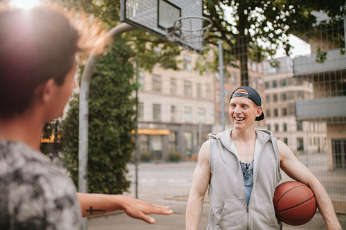 Happy young streetball players on court.