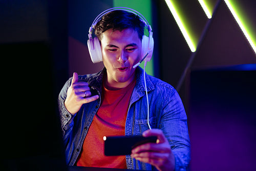 Young gamer connecting with other video game players on a video call