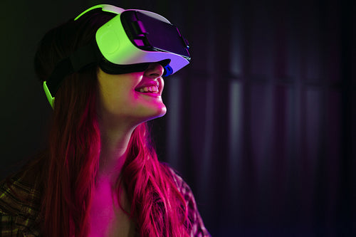 Going on a virtual adventure: Happy young woman wearing a vr headset