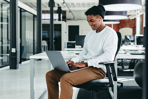 Happy young businessman working on a new project in the office